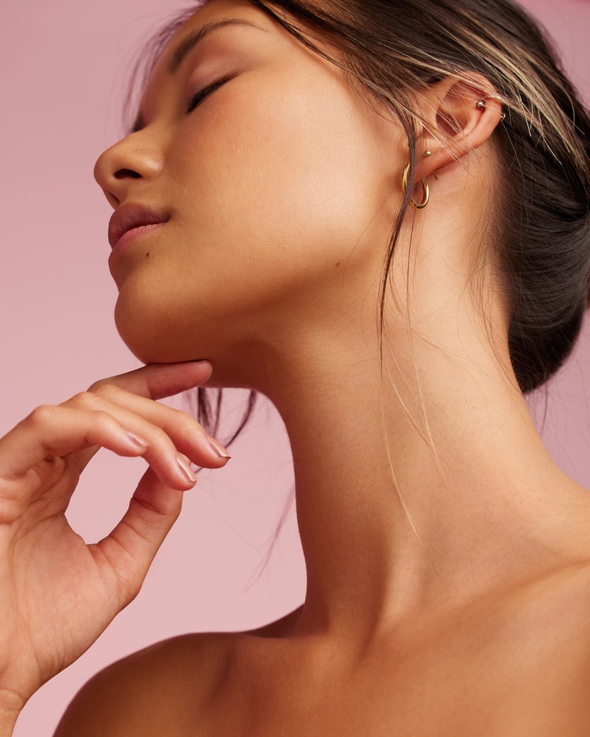 Close-up of smooth, glowing skin along the jaw and neck — Glowtober at Neoderma